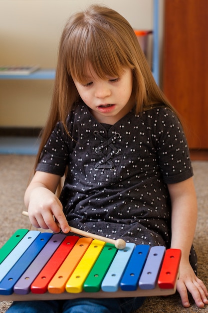 Girl with down syndrome playing with xylophone