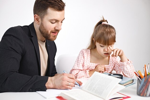 Girl with Down syndrome studying with her teacher at home