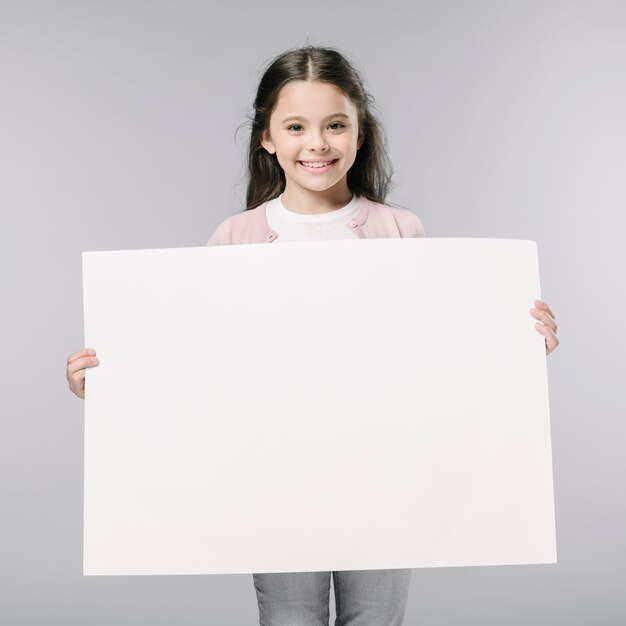Girl with empty poster in studio