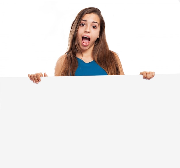 Girl with funny face showing a sign