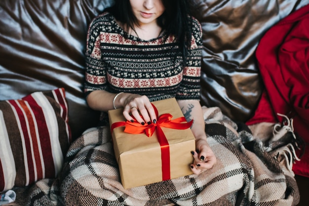 Girl with a gift on her lap