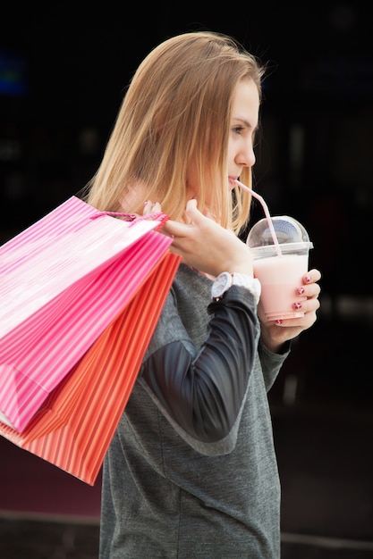 Girl with a glass and purchase bags