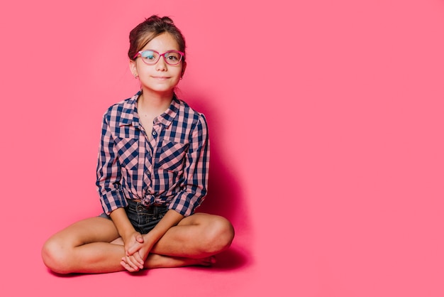 Free photo girl with glasses sitting