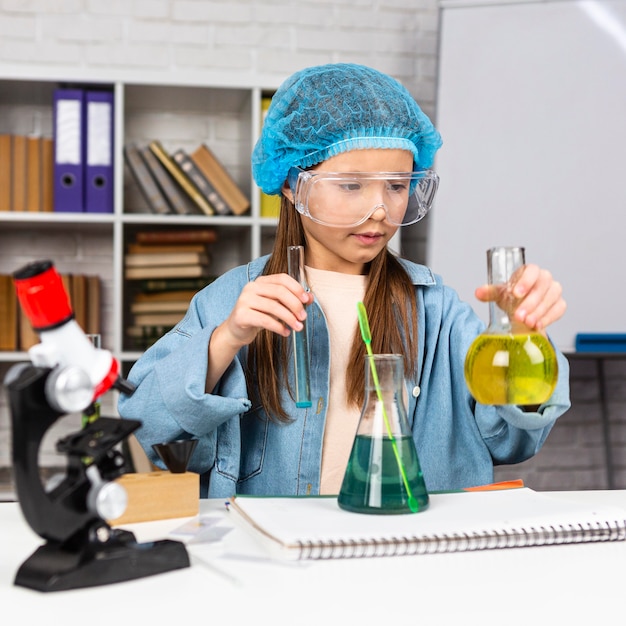 Girl with hair net doing science experiments