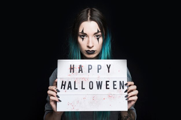 Girl with Halloween makeup and signboard