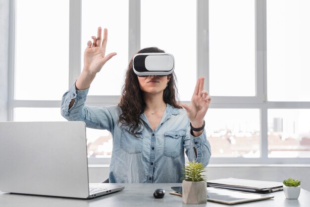 Girl with hands up wearing the virtual reality goggles