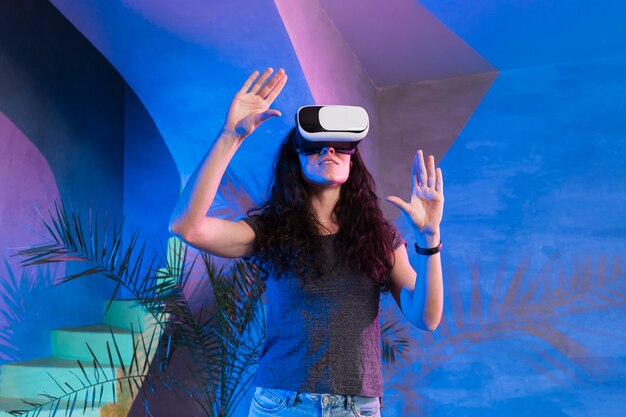 Girl with hands up wearing the vr set