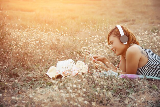 Girl with headphones while using her mobile