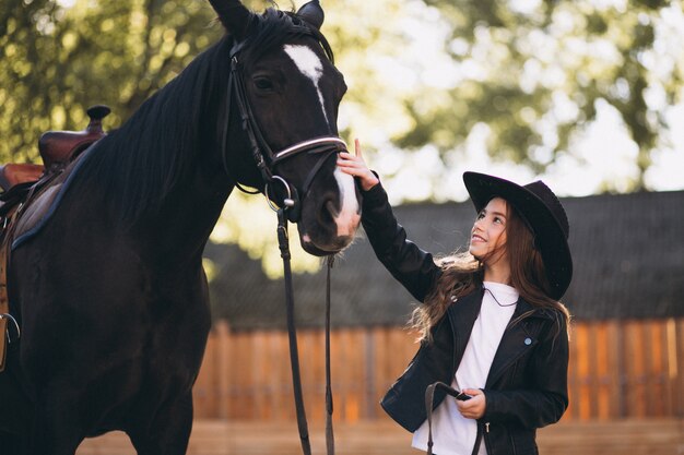 Girl with horse at ranch