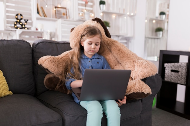 Free photo girl with laptop on couch