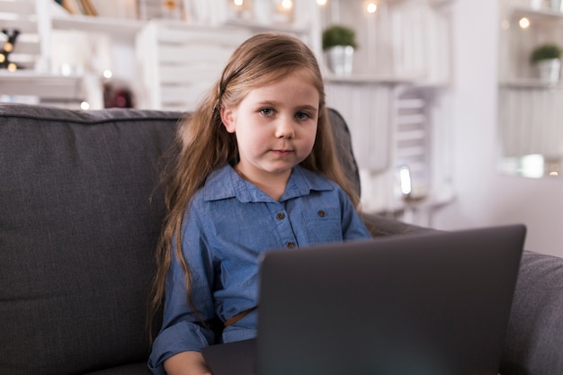 Girl with laptop on sofa