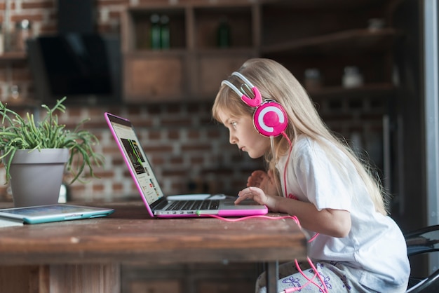 Girl with laptop at table