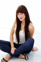 Free photo girl with long hair sitting on the floor