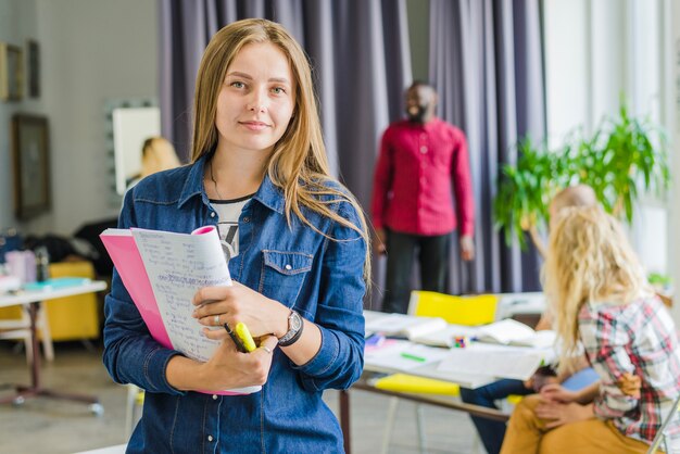 Girl with notepad posing confidently