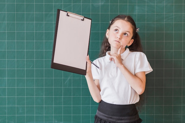 Free photo girl with paper holder near blackboard