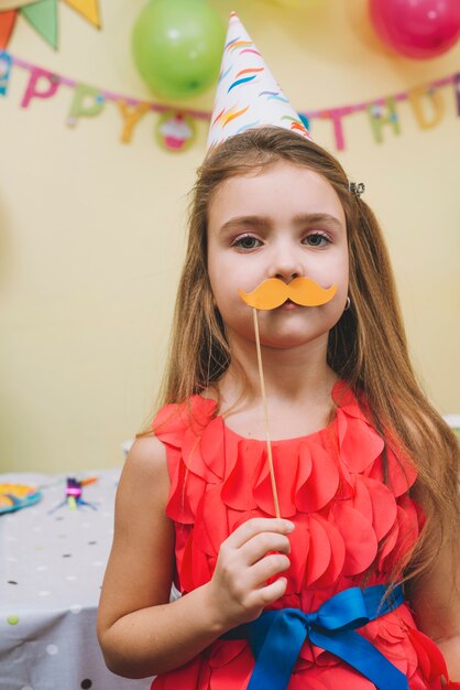 Girl with paper moustache