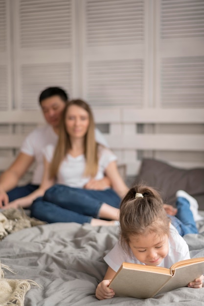 Girl with parents reading