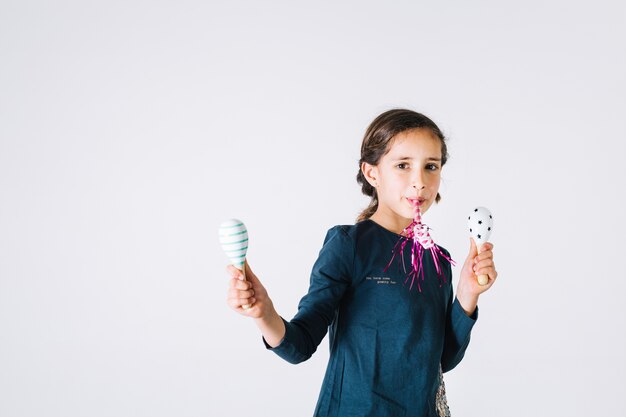 Girl with party horn and shakers