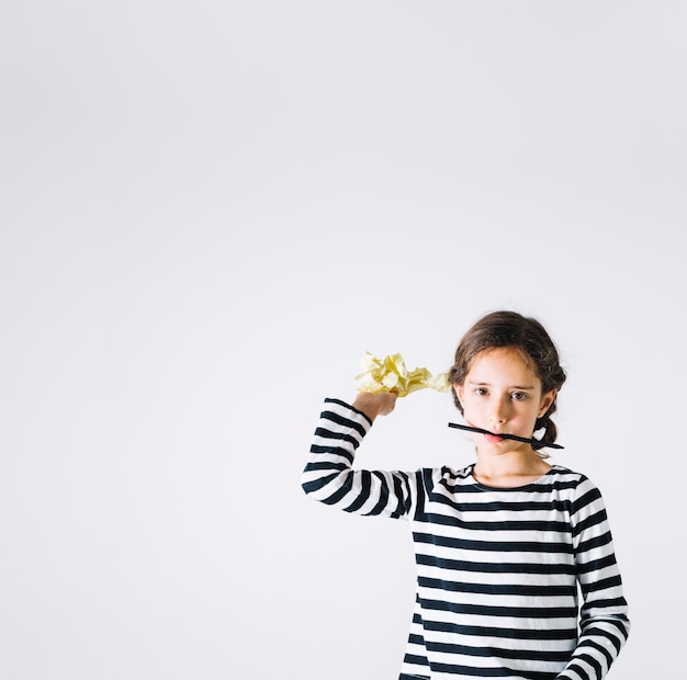 Girl with pencil throwing paper