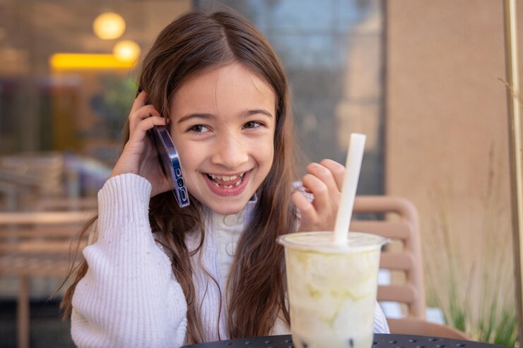 Free Photo a girl with a phone the girl is talking on the phone