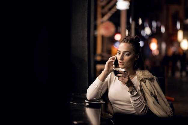 Girl with phone at night