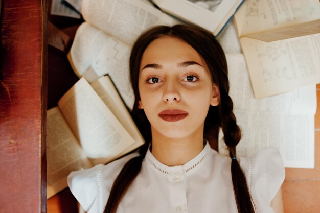 Girl with pigtails in white blouse at old library