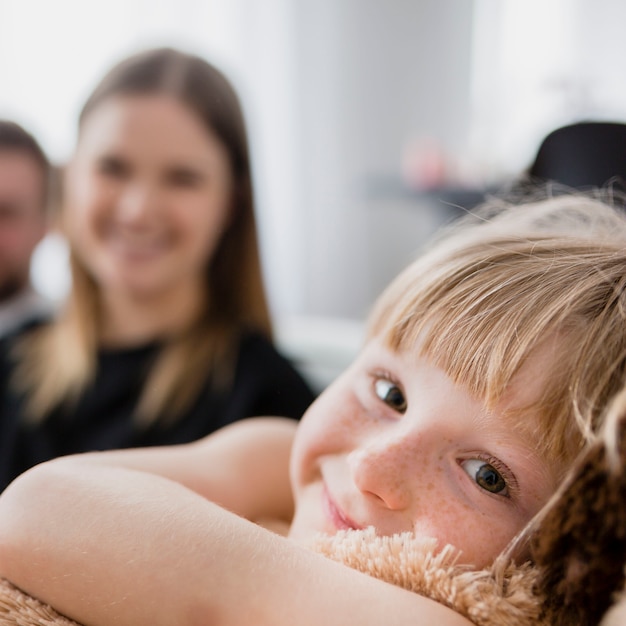 Girl with plush toy near parents