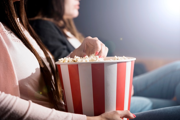 Girl with popcorn in cinema