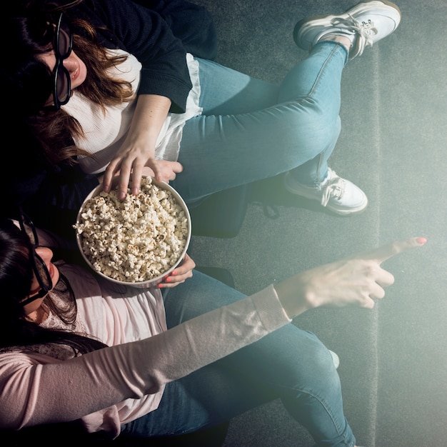 Free photo girl with popcorn in cinema