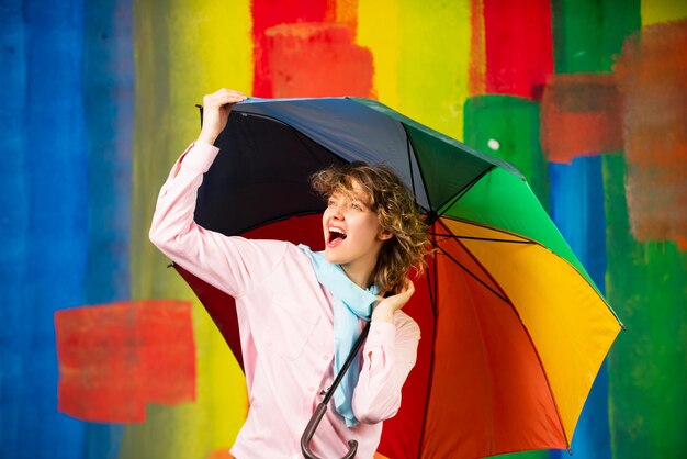 Girl with rainbow umbrella at rain weather rainy autumn mood woman