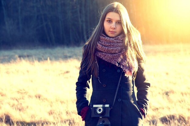 Girl with retro vintage camera.