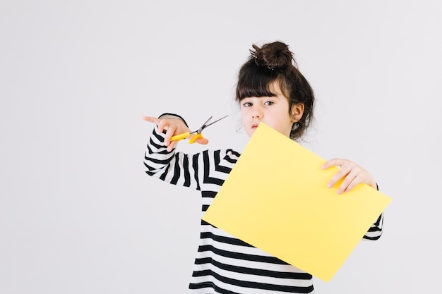 Free photo girl with scissors and paper