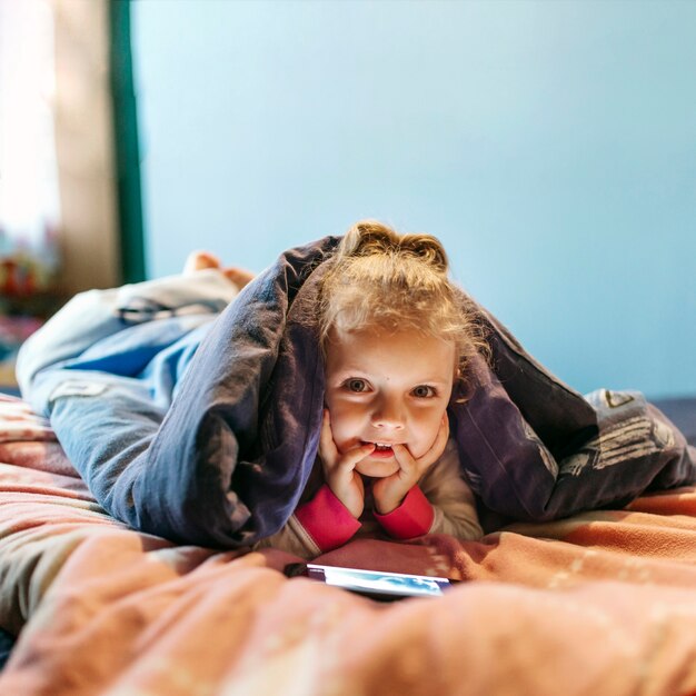 Girl with smartphone looking at camera