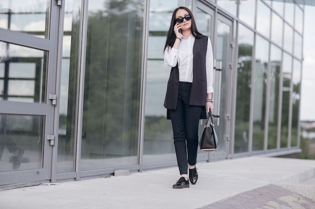 Girl with sunglasses talking on her phone