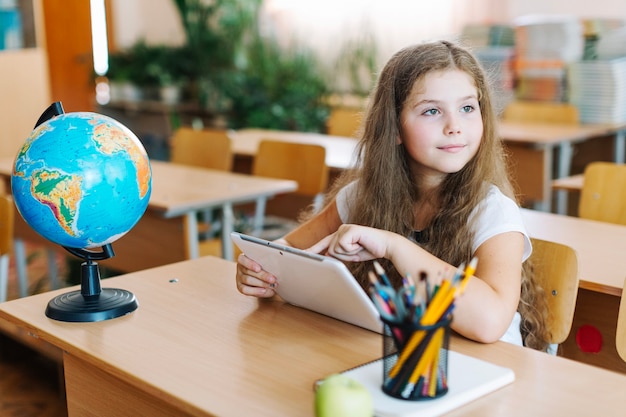 Free photo girl with tablet looking away