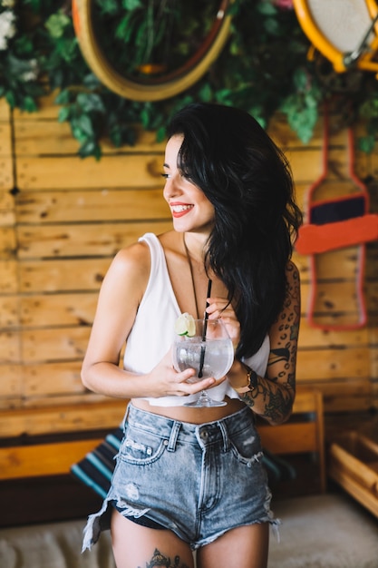 Free photo girl with tattoo and drink