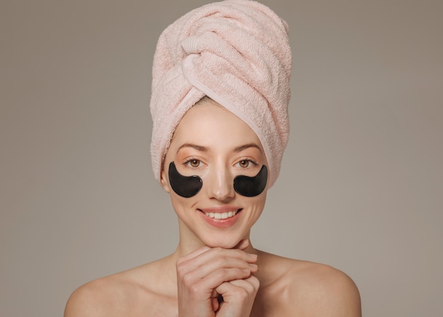 Free photo girl with towel on the head with face mask