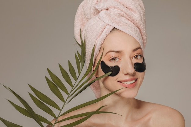 Girl with towel on the head with face mask