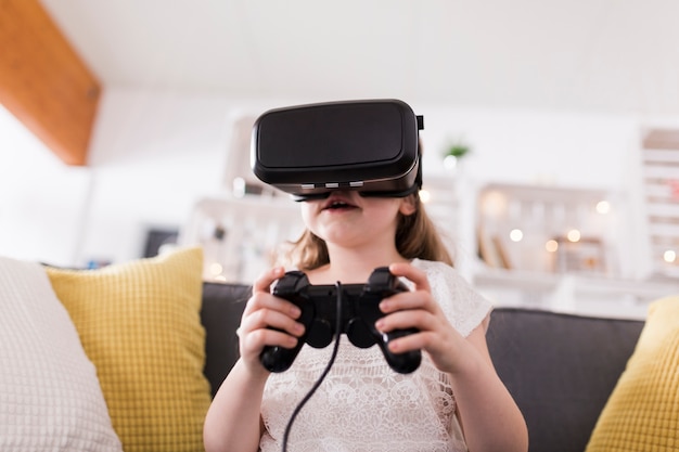 Girl with vr glasses and gamepad