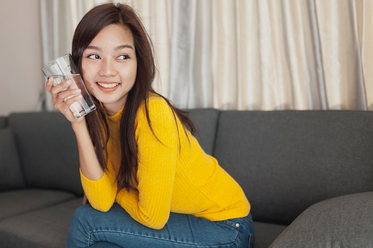 無料Photo 彼女の頬の隣に水ガラスの女の子