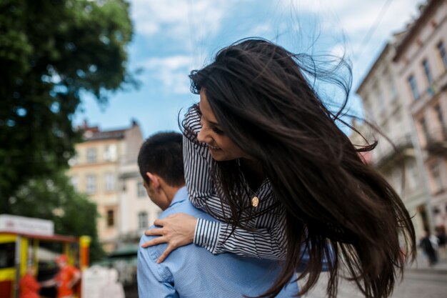 "Girl with waving hair on male shoulder"