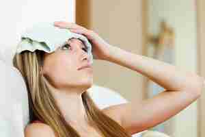 Free photo girl with wet towel on forehead