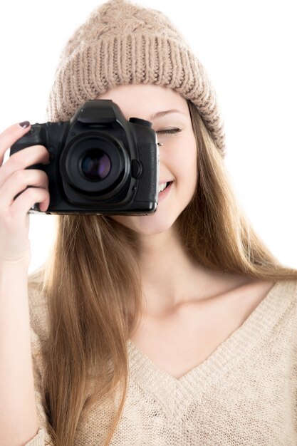 Girl with wool cap taking a photo