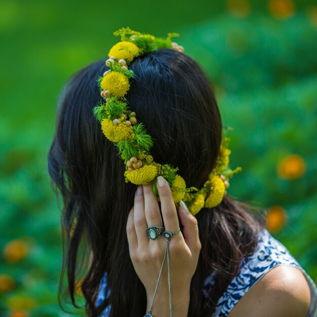 Girl with a yellow green floral wreath head band.