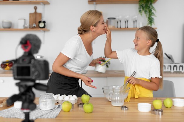 Girl and woman holding eggs medium shot