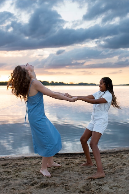 Girl and woman holding hands full shot