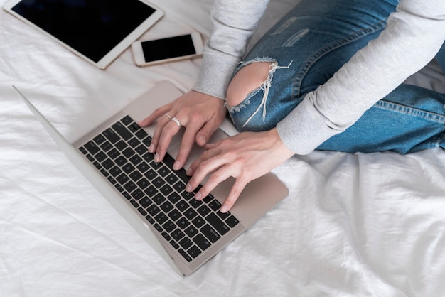 Free photo girl working on grey laptop