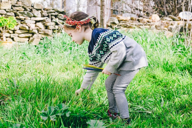 Girl in wreath playing in garden