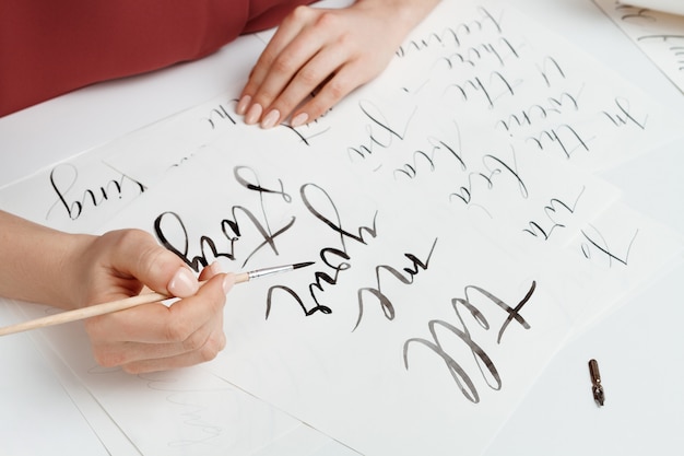 Girl writing calligraphy on postcards. Art design.