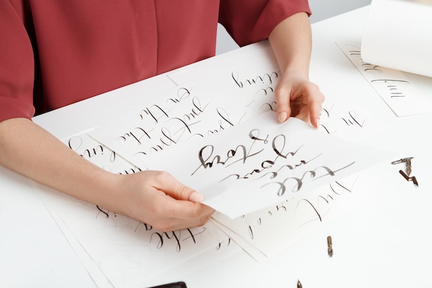 Girl writing calligraphy on postcards. Art design.